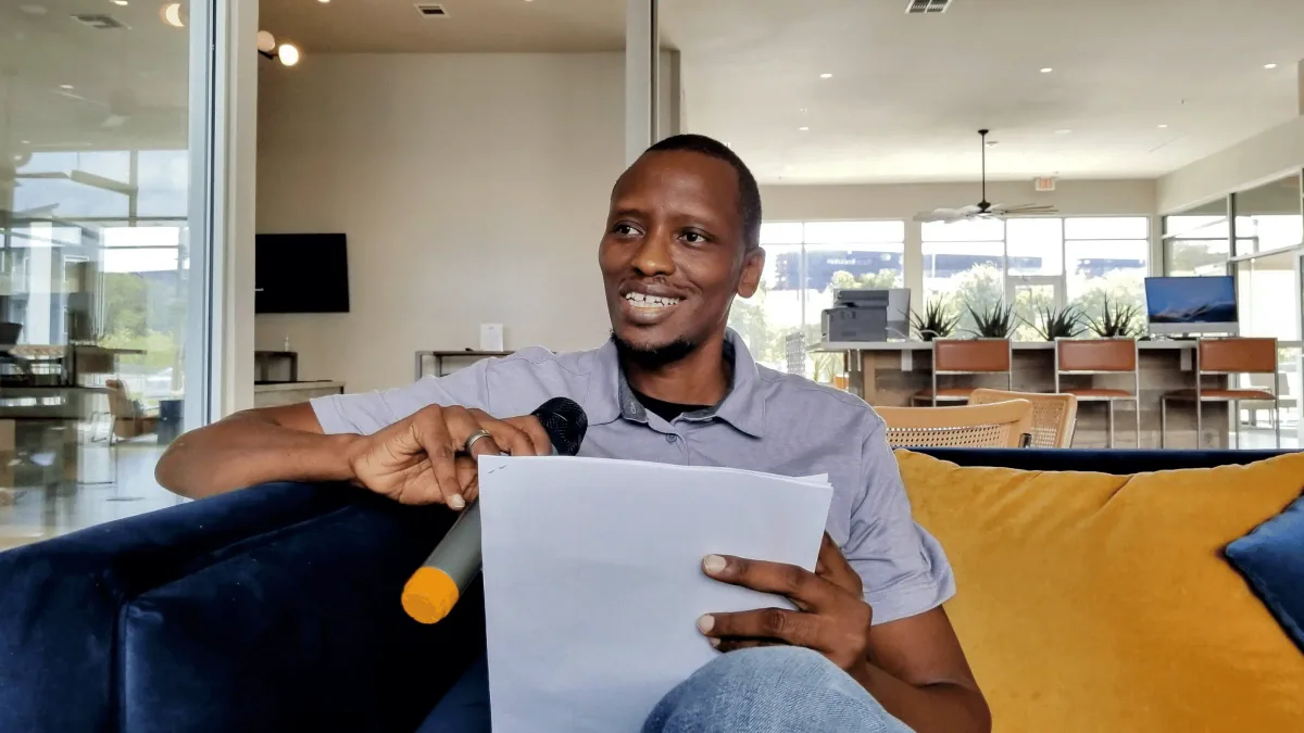 Pesa Shayo holding a microphone while teaching